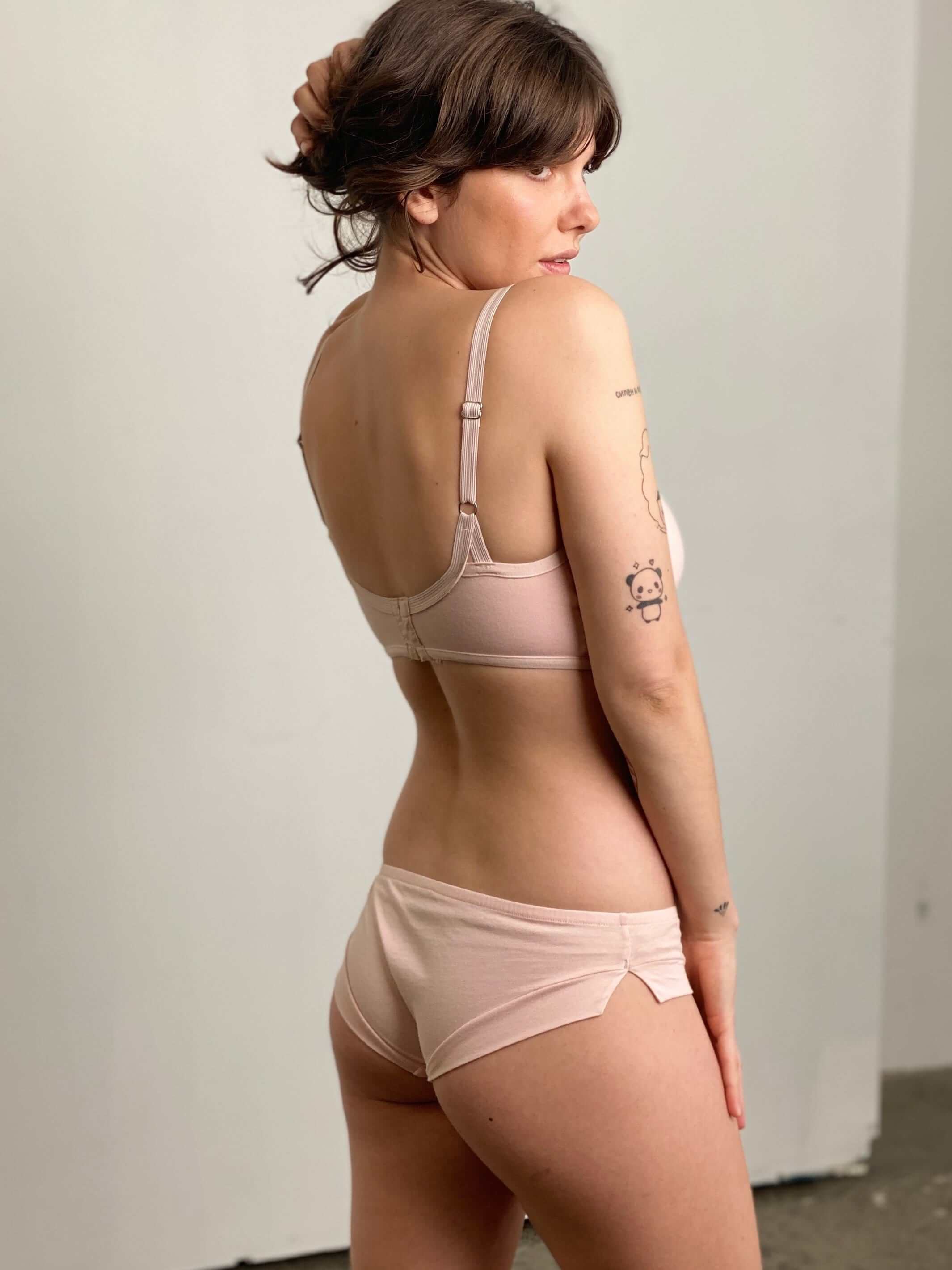 woman wearing a vintage peach bra and matching boy leg briefs, made from organic cotton