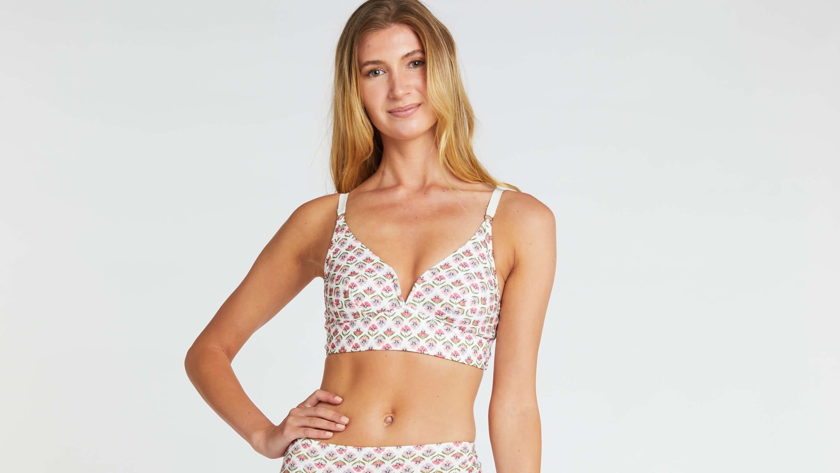 woman wearing an organic cotton bra in a floral print, a pansy bra made with liberty fabric. Matching pansy underwear