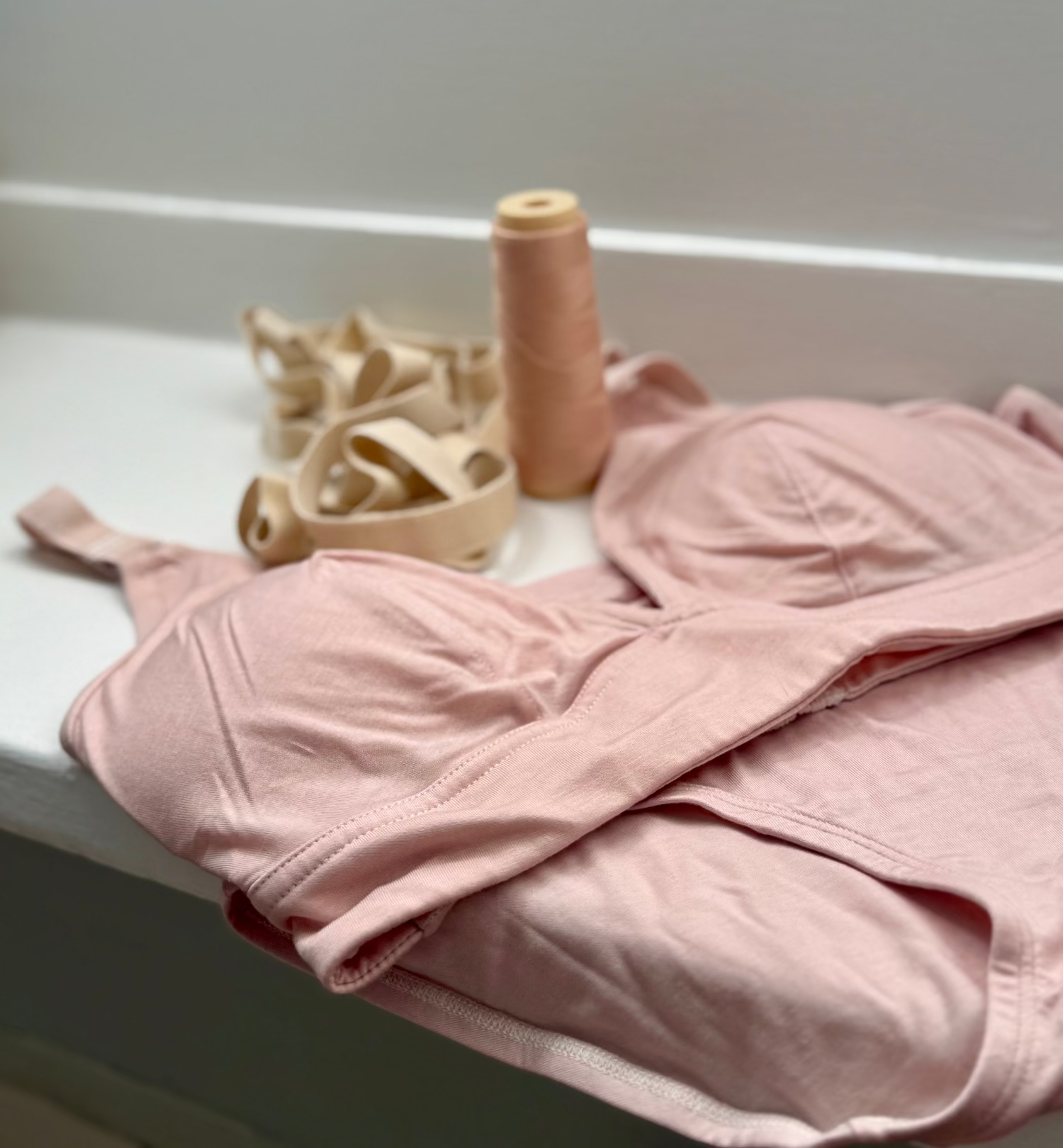 organic cotton bras with a soft cups laying on the window ledge with a pair of organic cotton super soft briefs