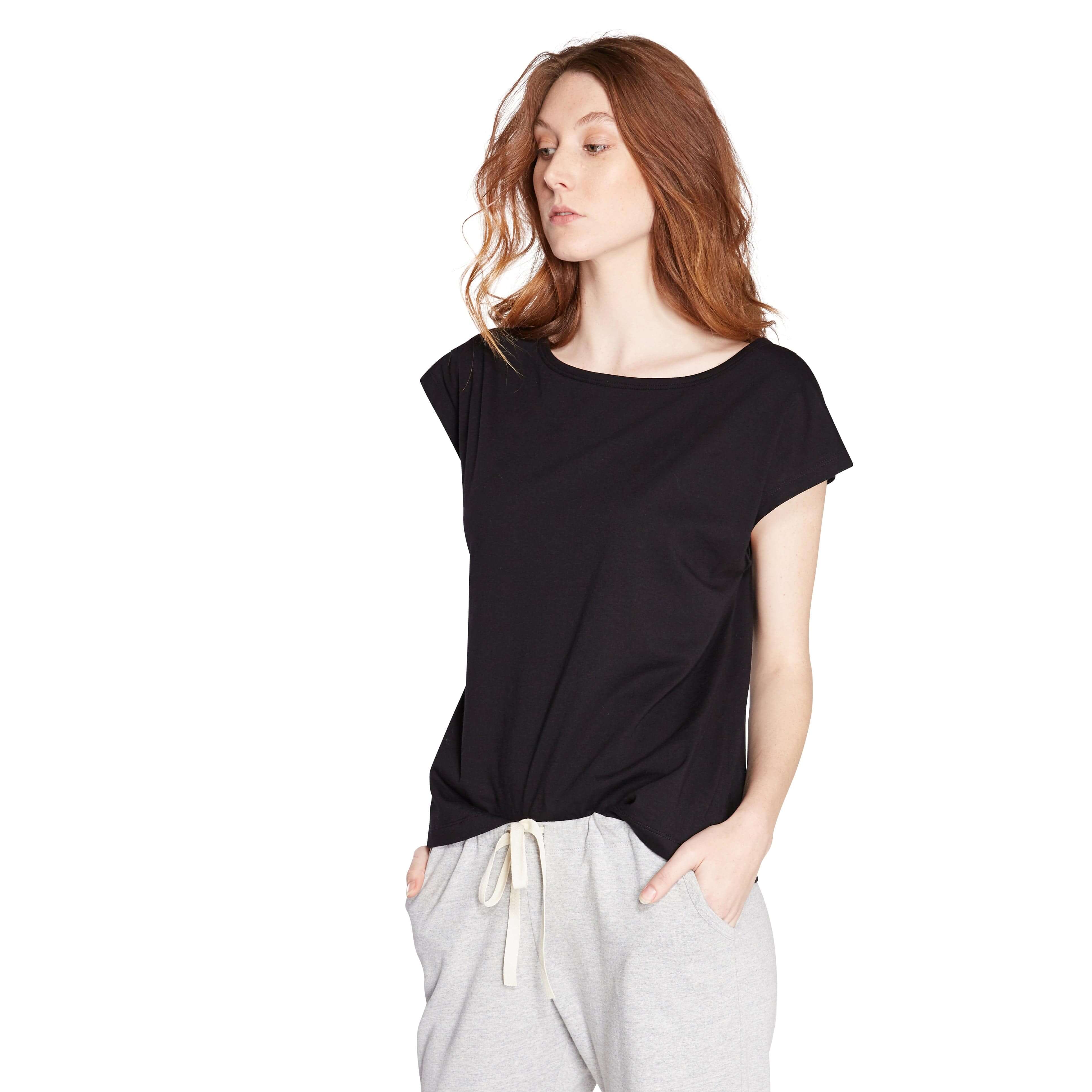 woman wearing black womens t shirt and grey marle long womens pants