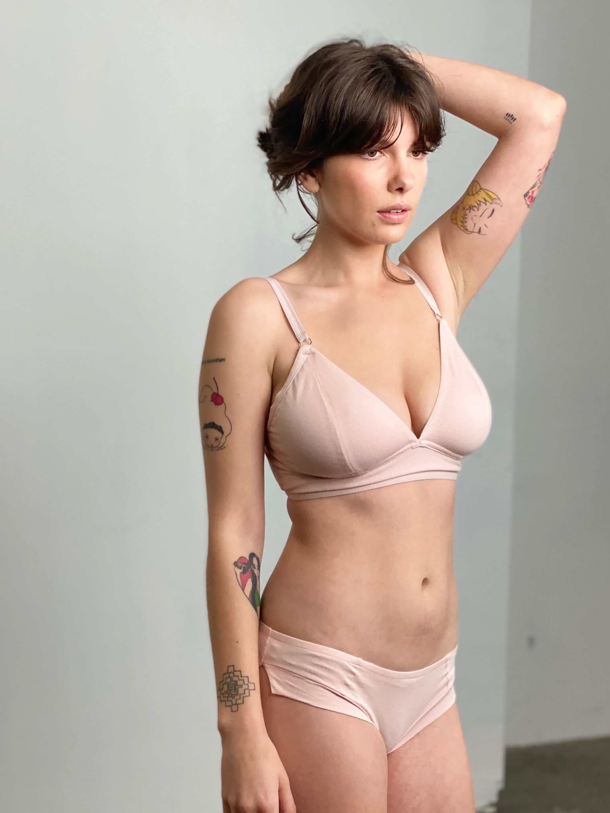 woman wearing a vintage peach bra and matching boy leg briefs, made from organic cotton