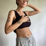 woman wearing black singlet with built in bra and grey marle organic cotton shorts