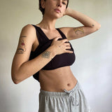 woman wearing black singlet with built in bra and grey marle organic cotton shorts