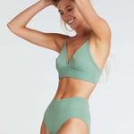 woman wearing sage green bra and matching high waist briefs in organic cotton